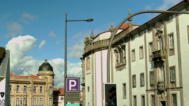 Fluffy cloud behind a done on a corner of a building in Porto.