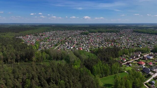 Panoramic aerial view of a small rural village in Western Lithuania surrounded by deep forest