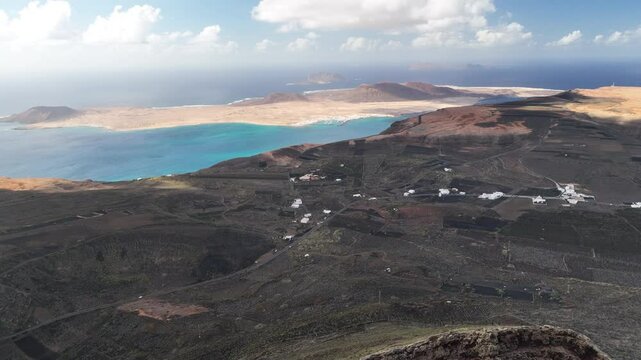 Massive Vulcan with view to La Graciosa Island and Farmland near Famara cliffs. Origin Farmland with picon floor on fields.