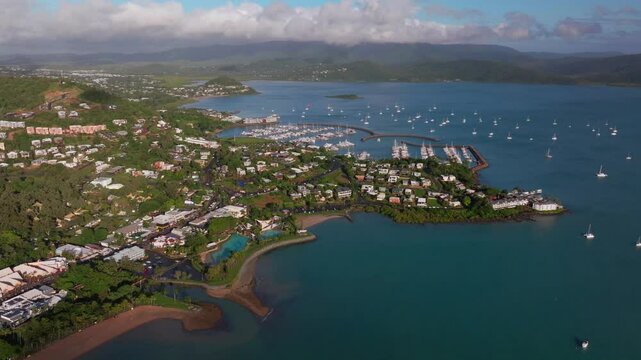 Airle Bay Beach aerial drone Coral Sea Marina Pioneer Bay Port Cannonvale heart of Great Barrier Reef Whitsundays islands Whitehaven sunrise morning mist clouds jetty sailboats backward reveal motion