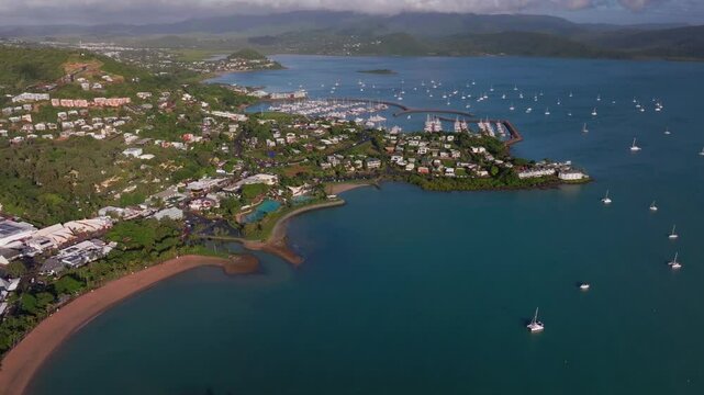 Airle Bay Beach Lagoon aerial drone Coral Sea Marina Pioneer Bay Port Cannonvale heart of Great Barrier Reef Whitsundays islands Whitehaven sunrise morning mist clouds jetty sailboats forward reveal