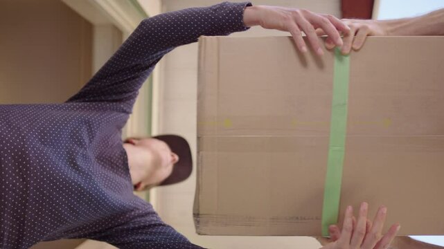 Home delivery of package by courier company, upwards ground-level view