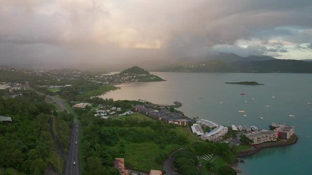 Port Airlie Beach Bay Lagoon Coral Sea marina aerial drone road cars towards Cannonvale pink yellow sunrise morning rain heart of Great Barrier Reef Whitsundays Whitehaven jetty yachts backward motion