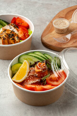 Tasty poke bowls on gray textured surface