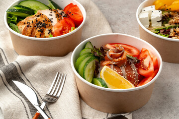 Beautiful composition with poke bowls on gray background with napkin