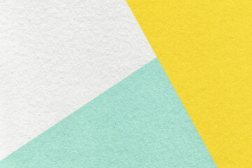 Texture craft white, light cyan and yellow color paper background, macro. Vintage abstract mint cardboard