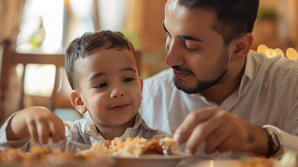 Close-up of Middle Eastern man with his son eating during Ramadan meal at home