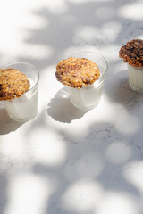 banana chocolate oatmeal cookies with milk on marble table in morning sunlight.