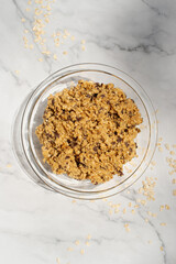 homemade banana oatmeal chocolate chip cookies dough in a glass bowl.
