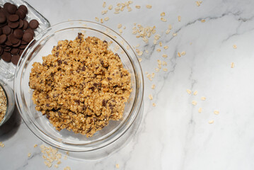 homemade banana oatmeal chocolate chip cookies dough in a glass bowl.