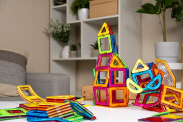 Magnetic constructor buildings on the table. Educational toys