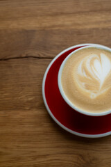 Red Mug of Latte Coffee on Wooden Table