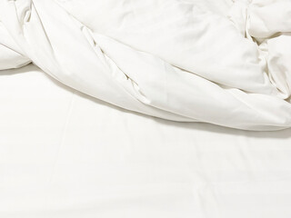 Obraz premium wrinkle messy blanket and white pillow in bedroom after waking up in the morning, from sleeping in a long night, details of duvet and blanket, an unmade bed in hotel bedroom with white blanket