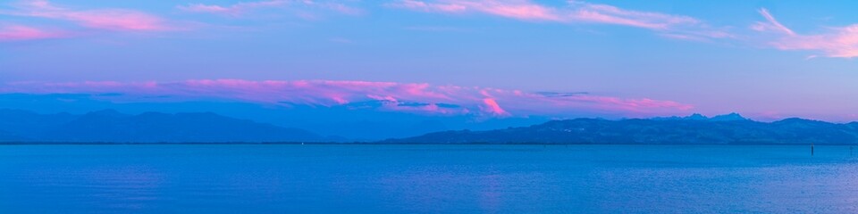 Germany, XXL panorama sunset light, alps mountains, swiss and austrian coast, saentis peak and coastline in magical atmosphere