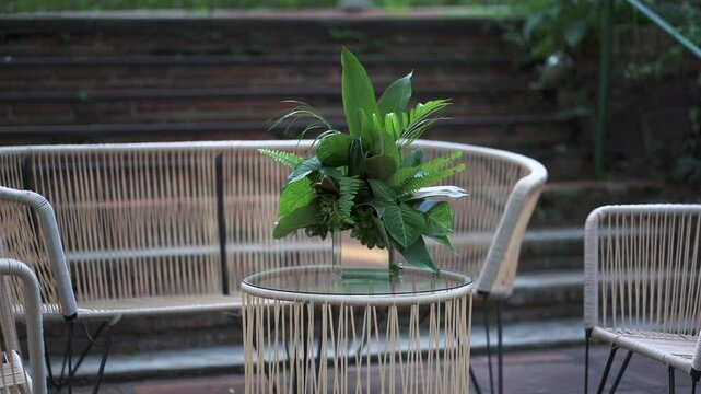 Pan shot of flowers in pots as part of the wedding decoration on the table