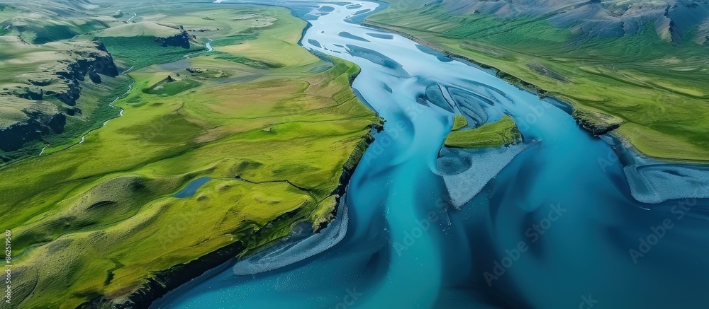 Wall mural Aerial View of a River Winding Through Lush Green Landscape - Wall murals