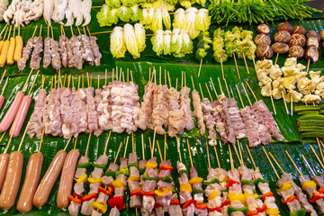 Vegetables, mushrooms and meat on wooden skewers