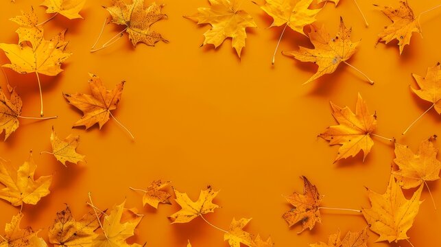 Autumn vibes with scattered yellow maple leaves on orange background