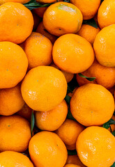orange mandarin background of fresh juicy tangerines close up, vegan friut conception of citrus