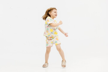 Happy smiling child having fun on white studio background. The concept of childhood and childish emotions.