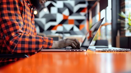 The person typing on laptop