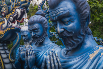 Statues of men praying