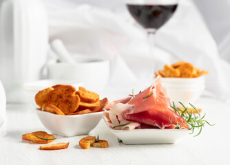 Prosciutto, spicy bruschetta crackers and glass of red wine.