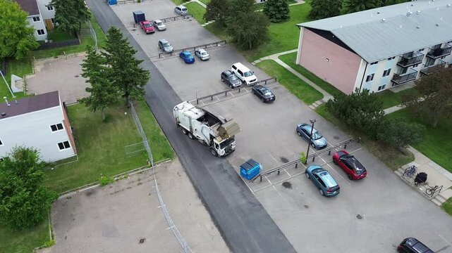 Garbage Truck Picking up garbage in a parking lot, no company marking
