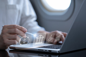 Businessman using laptop analyzing sales data and economic, on an airplane