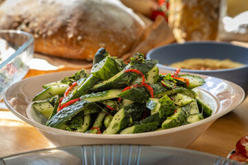 A close up of a healthy salad displayed on a table, with a shallow depth of field