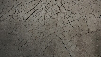 Obraz premium Close-up view of a cracked cement surface with detailed texture.