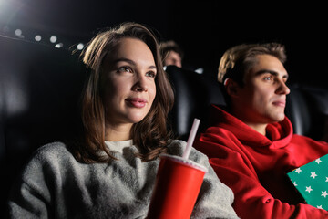 Close-up of a young woman while watching a melodrama at the cinema