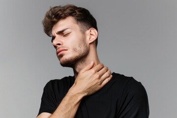 Obraz premium Turn Away. Man Experiencing Intense Neck Pain, Half Face Profile in Studio Setting