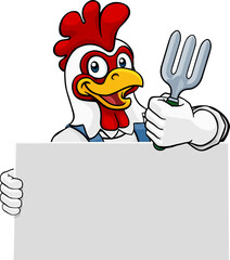 A gardener, farmer or handyman chicken rooster cartoon mascot man holding a gardening tool