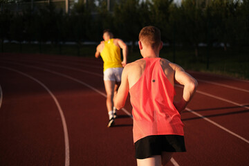 Obraz premium Athletes compete in running at the stadium