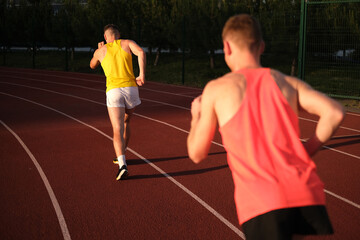 Obraz premium Athletes compete in running at the stadium