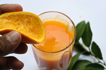 Fresh Orange juice on white background. It is a famous fruit juice which contains lots of vitamins like vitamin C, folate and potassium. Healthy drink. Fruit juice.
