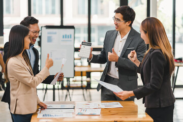 Business team clapping and celebrating success during meeting in modern office.