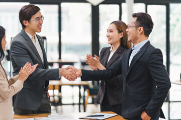 Successful business people shaking hands during a meeting in the office.