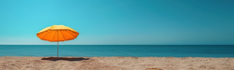 Yellow umbrella on the beach near the ocean, Banner, Travel concept