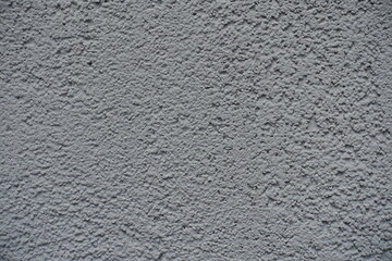 Macro of gray wall with coarse roughcast finish