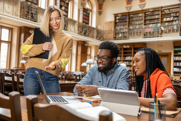 Team of students looking involved and interested while working in the library