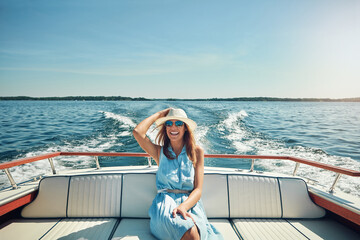 Relax, travel or happy woman on boat on ocean for outdoor vacation or holiday on summer adventure. Cruise, tourist and person with smile, fashion or hat on yacht on sea for weekend trip in Greece
