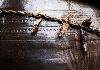 It is an old Korean custom that wraps a rope filled with red peppers around a jar to make soybean paste delicious.붉은 고추를 꽂은 새끼줄을  항아리에 감싸면 된장이 맛있게 된다는 옛날 한국풍습입니다