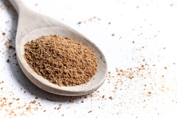 Coconut palm sugar on a wooden spoon isolated on white background. Copy space