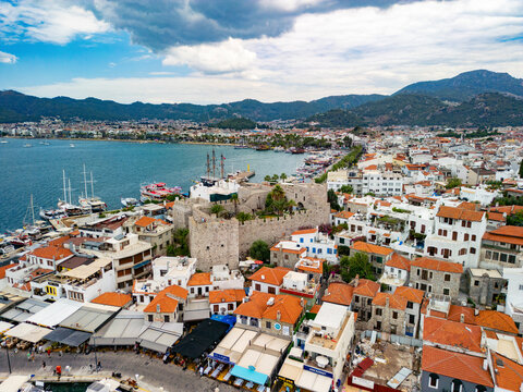 Aerial view of Castle overlooking harbor with boats and mountains, Marmaris, Mugla, Turkey.