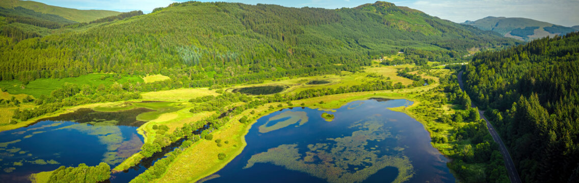 Aerial view of Loch Lubnaig surrounded by lush greenery and majestic mountains, Callander, Scotland, United Kingdom.