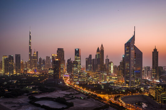 Aerial view of illuminated Dubai cityscape at twilight, United Arab Emirates.