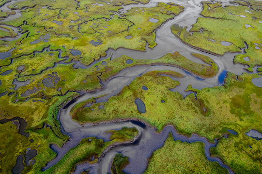 Aerial view of meandering river through wetlands and grass, Wells, Maine, United States.