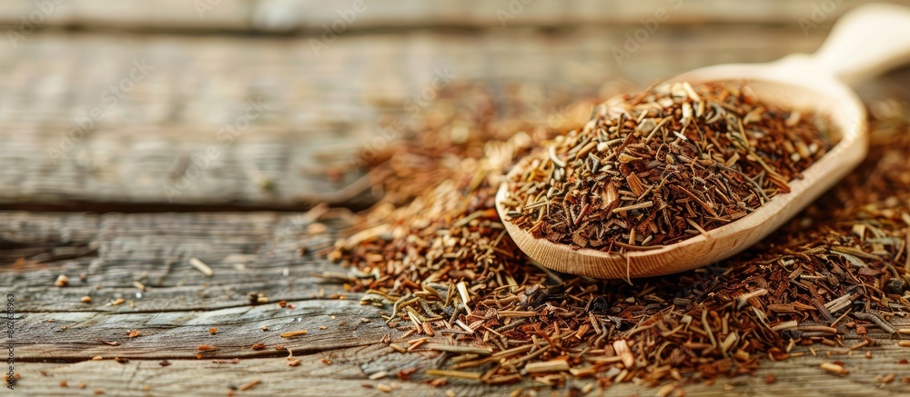 Poster close-up image featuring a pile of dried rooibos tea leaves and a wooden spoon, with a designated ar